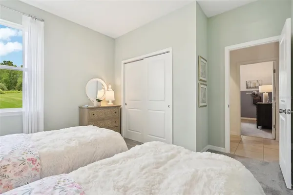a bedroom with a bed and window