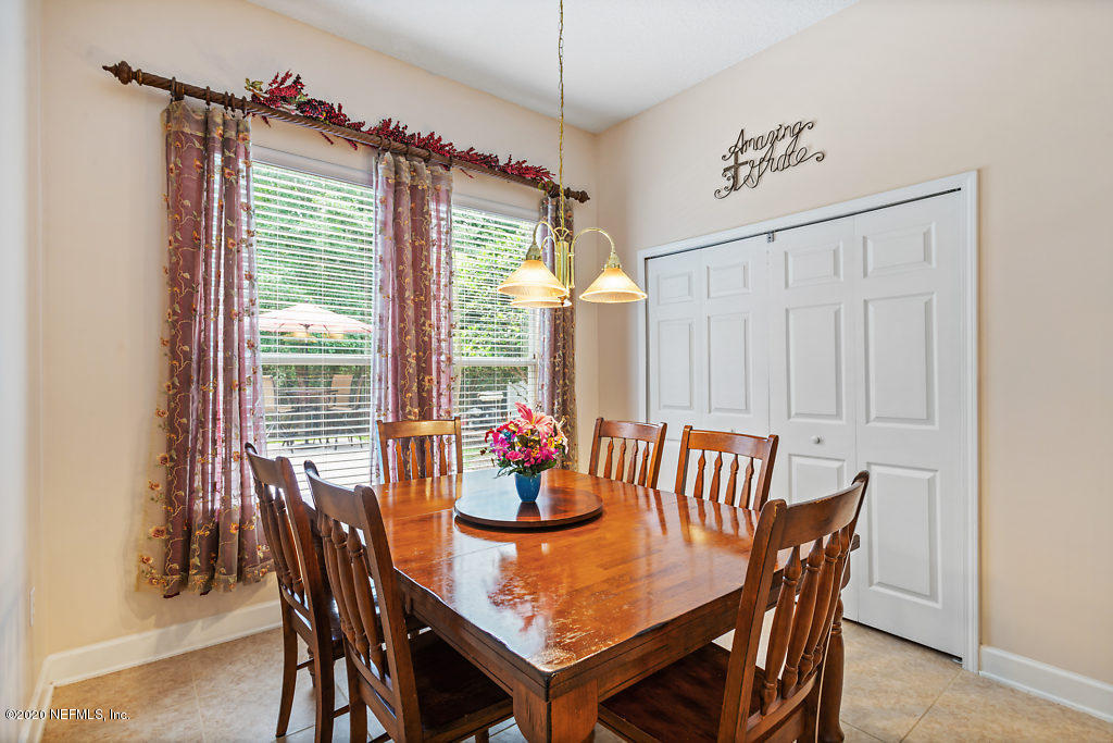 3824 Reds Gait Lane Jacksonville, FL 32223 - Photo 17 of 68 a view of a dining room with furniture wooden floor and a chandelier