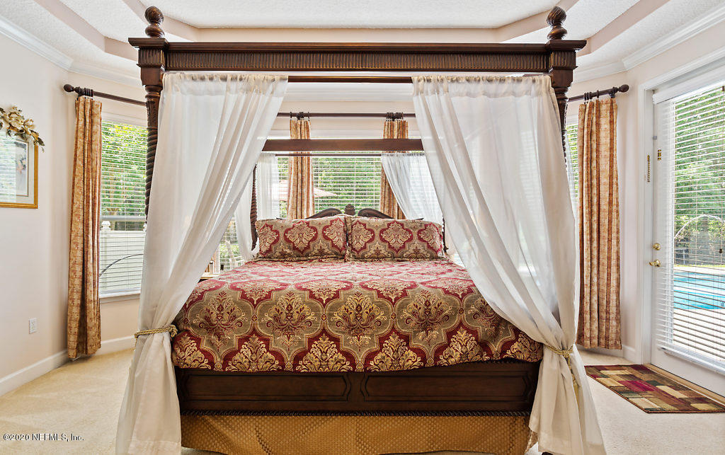 3824 Reds Gait Lane Jacksonville, FL 32223 - Photo 24 of 68 a bed sitting in a bedroom next to a window