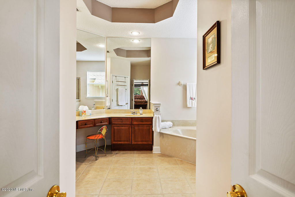 3824 Reds Gait Lane Jacksonville, FL 32223 - Photo 27 of 68 a bathroom with a tub sink and mirror