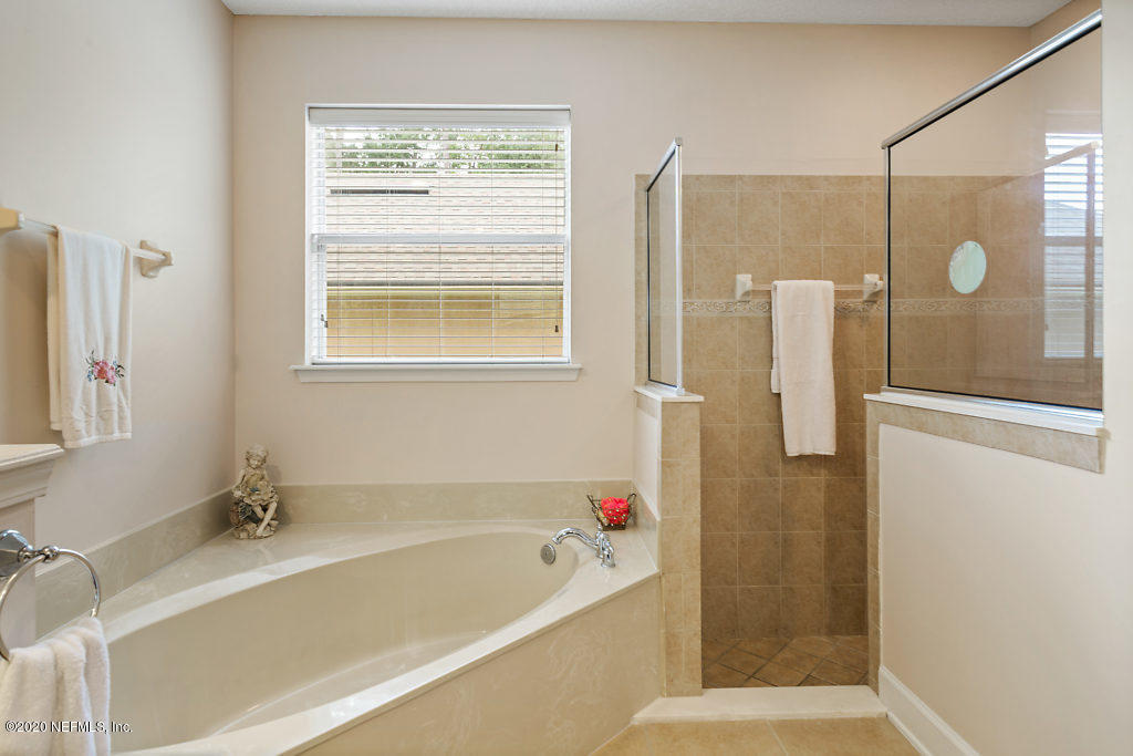 3824 Reds Gait Lane Jacksonville, FL 32223 - Photo 29 of 68 a bathroom with a bathtub and a shower
