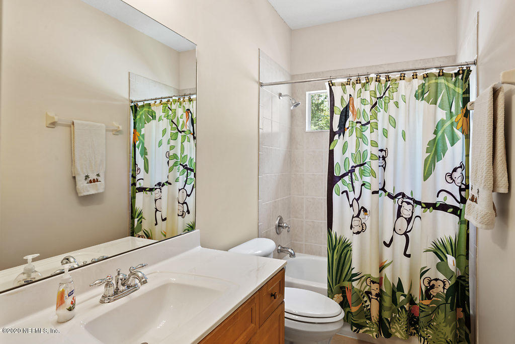 3824 Reds Gait Lane Jacksonville, FL 32223 - Photo 40 of 68 a bathroom with a sink and mirror with toilet