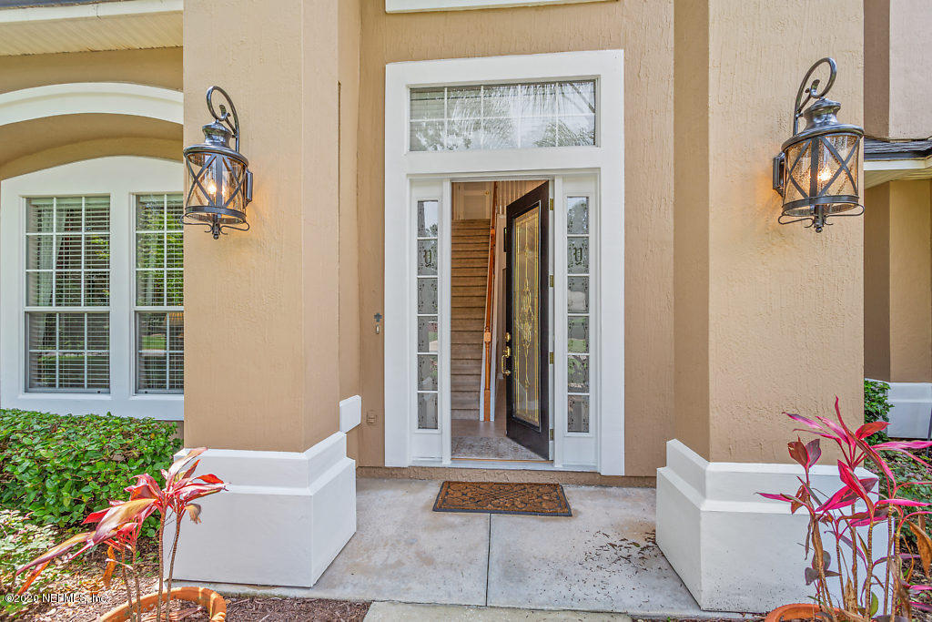 3824 Reds Gait Lane Jacksonville, FL 32223 - Photo 4 of 68 a front view of a house with outdoor seating and potted plants