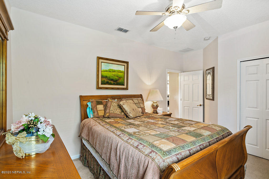 3824 Reds Gait Lane Jacksonville, FL 32223 - Photo 44 of 68 a bedroom with a bed and ceiling fan