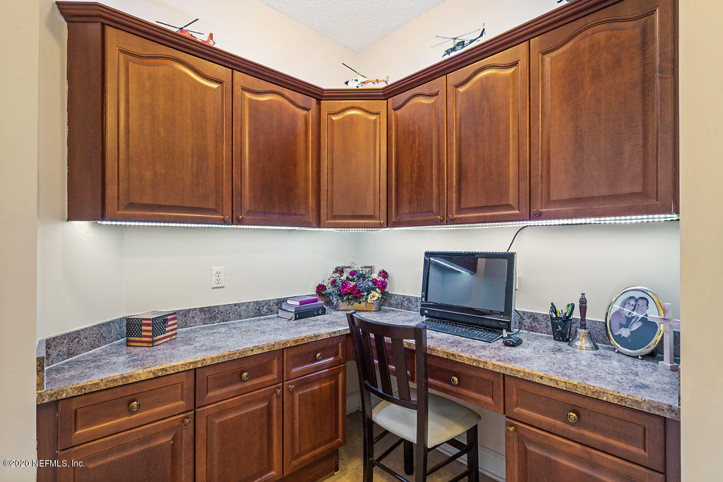 3824 Reds Gait Lane Jacksonville, FL 32223 - Photo 49 of 68 a kitchen with granite countertop a sink cabinets and stainless steel appliances