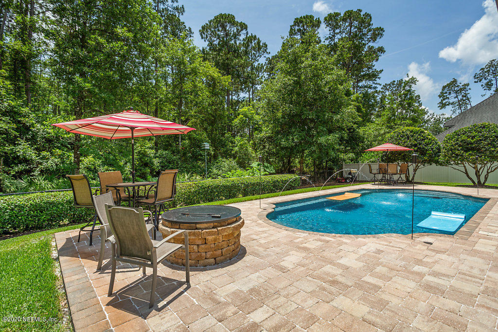 3824 Reds Gait Lane Jacksonville, FL 32223 - Photo 59 of 68 a view of a swimming pool with lawn chairs under an umbrella