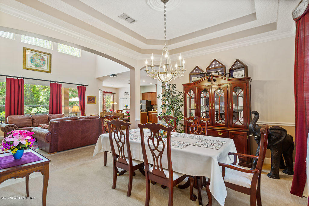 3824 Reds Gait Lane Jacksonville, FL 32223 - Photo 9 of 68 a view of a dining room with furniture and chandelier