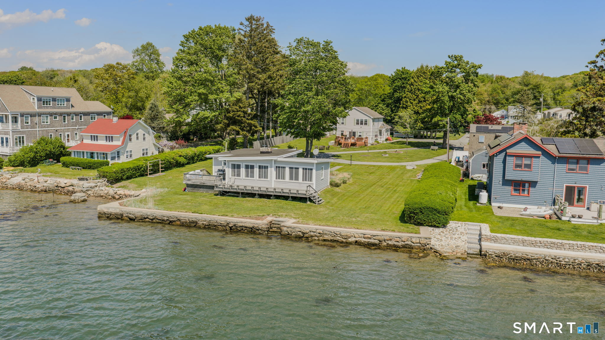 210 Shore Road Waterford, CT 06385 - Photo 9 of 26 a view of a house with a yard and sitting area