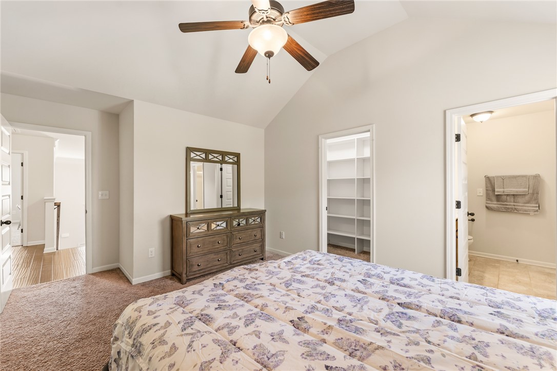 5 Tolkien Drive Anderson, SC 29621 - Photo 26 of 36 Vaulted ceilings soar above this comfortable bedroom featuring plush carpeting and dual doorways.