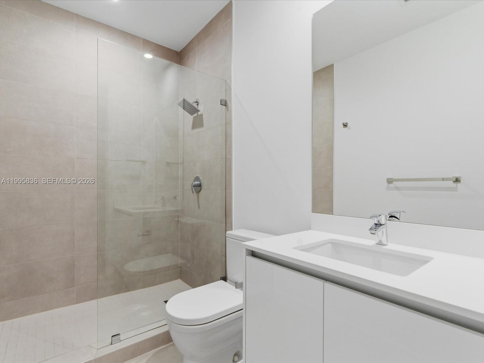 529 Southwest 11th Street, Unit 303 Miami, FL 33129 - Photo 12 of 35 a bathroom with a sink a toilet and shower