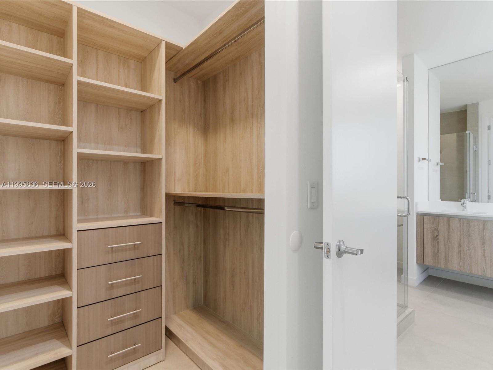 529 Southwest 11th Street, Unit 303 Miami, FL 33129 - Photo 16 of 35 a view of walk in closet with empty racks
