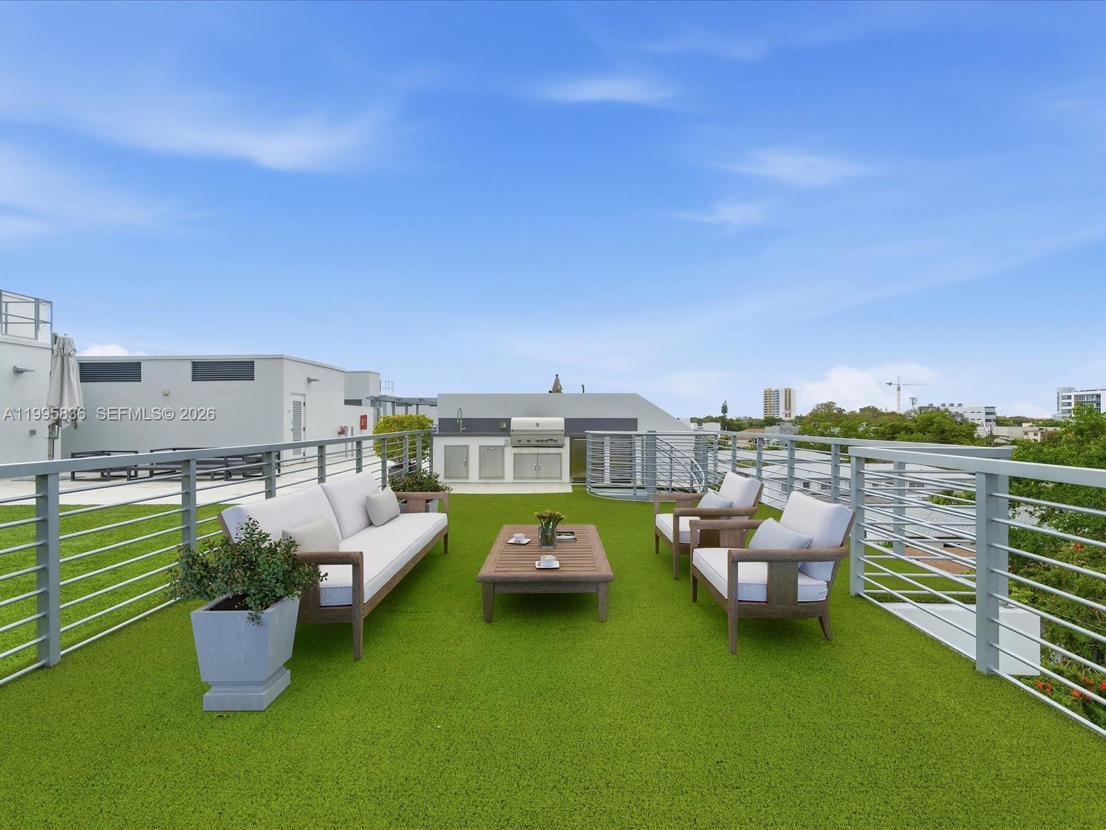 529 Southwest 11th Street, Unit 303 Miami, FL 33129 - Photo 28 of 35 a patio with table and chairs