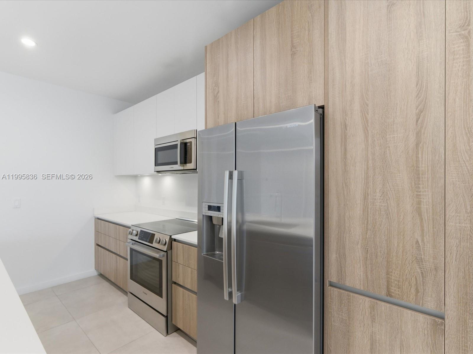529 Southwest 11th Street, Unit 303 Miami, FL 33129 - Photo 8 of 35 a kitchen with metallic refrigerator freezer and a dishwasher