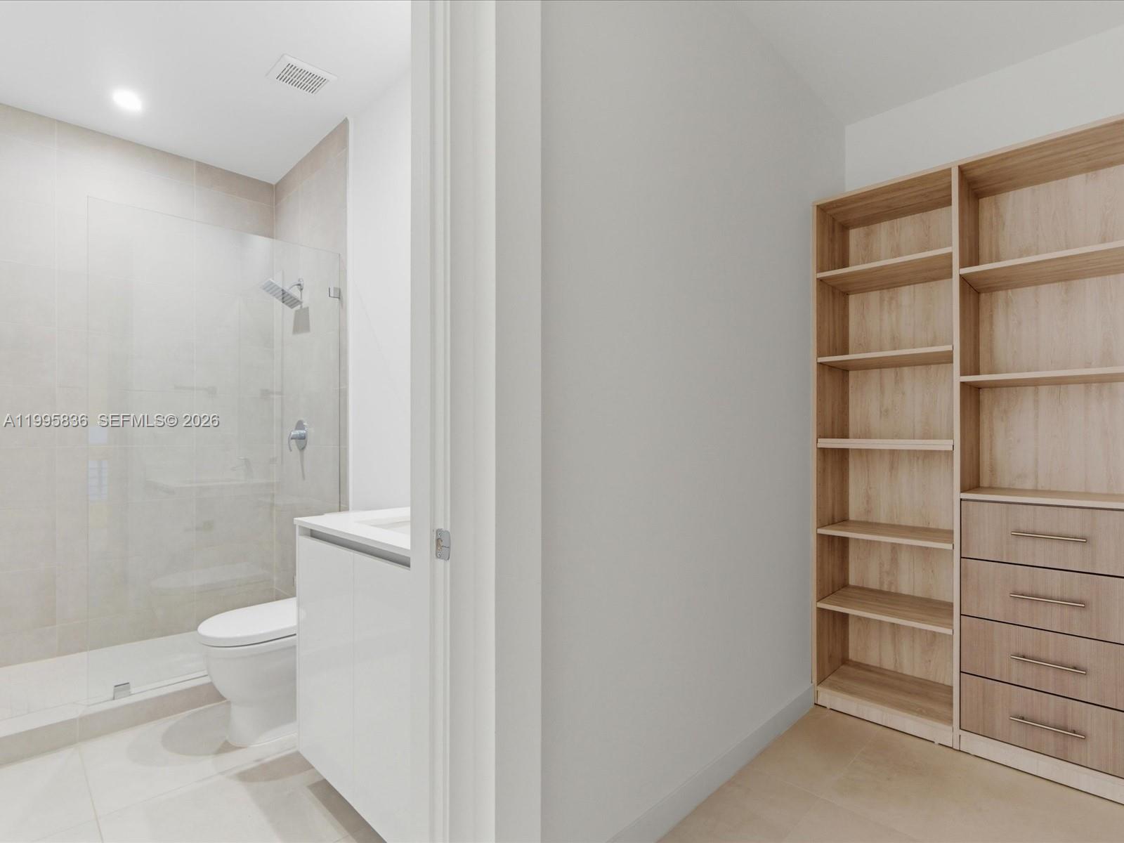 529 Southwest 11th Street, Unit 303 Miami, FL 33129 - Photo 9 of 35 a bathroom with a toilet and a shower