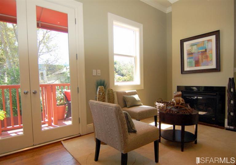3973 Cesar Chavez San Francisco, CA 94131 - Photo 18 of 46 Welcoming great room with bright southern exposure features a warm gas fireplace, hardwood floors and opens on to the deck and garden below.