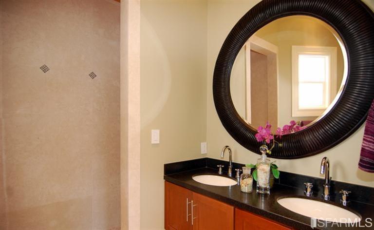 3973 Cesar Chavez San Francisco, CA 94131 - Photo 25 of 46 Main level master bedroom with French doors that open onto a sweet step-out balcony that overlooks the patio and garden. This room features a custom "spa-like" bath with rain shower, custom cabinetry, and granite counters.