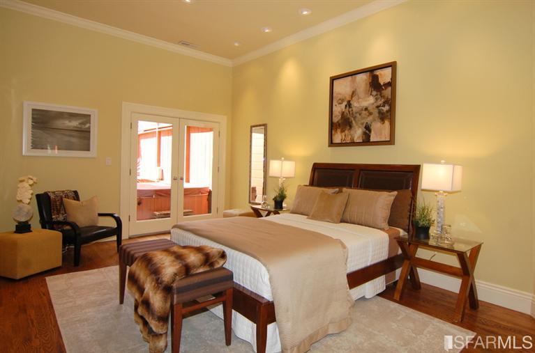 3973 Cesar Chavez San Francisco, CA 94131 - Photo 29 of 46 The lower level master suite with French doors out to the "Spa" hot tub, patio and garden features soaring 11' ceilings, hardwood floors, custom lighting, two generous closets with custom built-ins and a "spa-like" bath with rain shower.