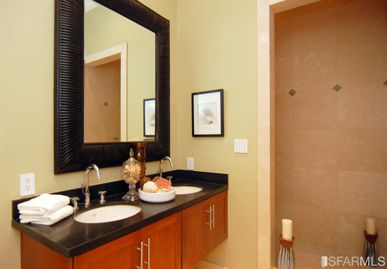 3973 Cesar Chavez San Francisco, CA 94131 - Photo 32 of 46 The lower level master suite with French doors out to the "Spa" hot tub, patio and garden features soaring 11' ceilings, hardwood floors, custom lighting, two generous closets with custom built-ins and a "spa-like" bath with rain shower.