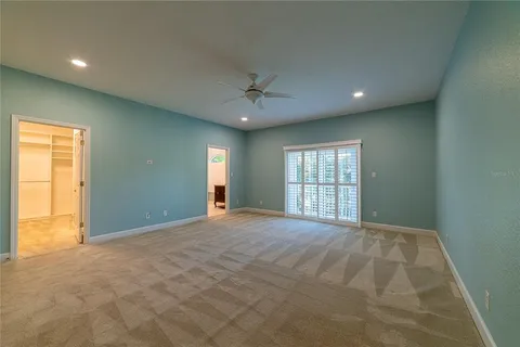 a room with walk in closet with empty racks