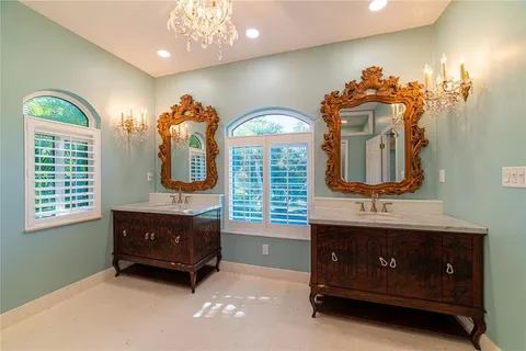 a bathroom with a sink a toilet and mirror