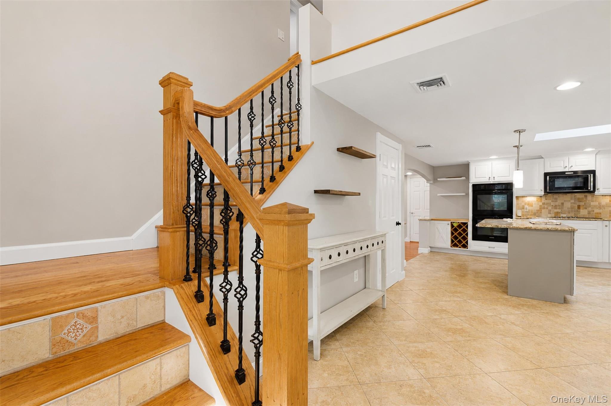 12 Leeside Road Carmel, NY 10512 - Photo 23 of 44 Hardwood staircase featuring wrought iron balusters and tiled risers