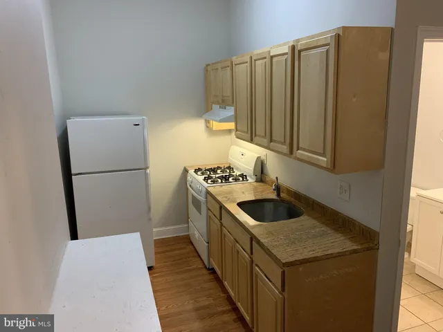 a kitchen with a sink and a refrigerator