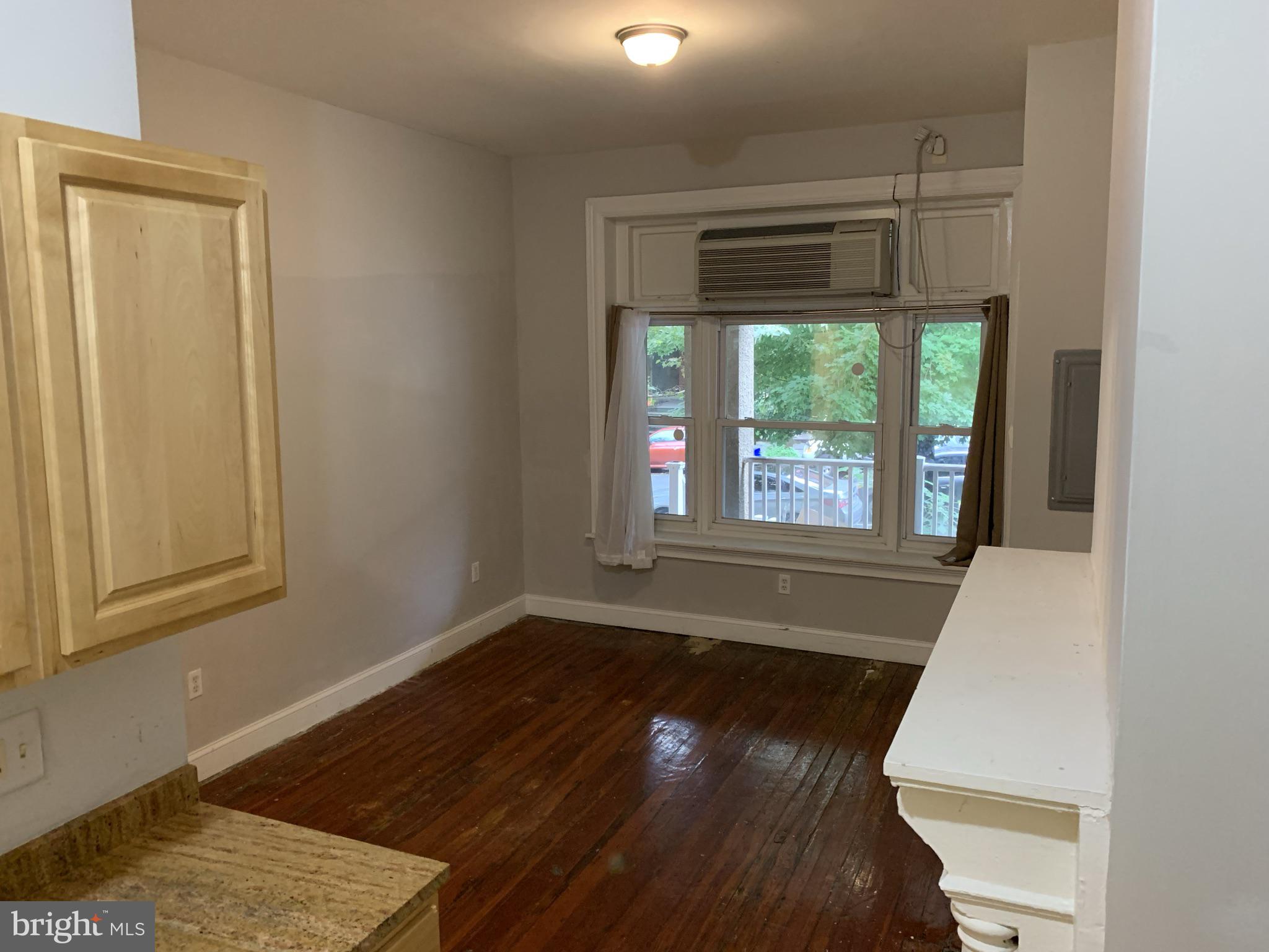 4437 Chestnut Street, Unit 1F Philadelphia, PA 19104 - Photo 11 of 15 a view of an empty room with wooden floor and a window