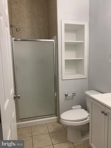 a bathroom with a toilet and a shower