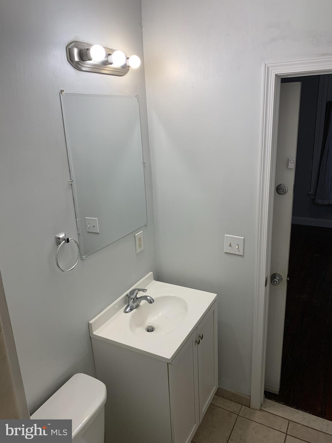 4437 Chestnut Street, Unit 1F Philadelphia, PA 19104 - Photo 15 of 15 a bathroom with a sink toilet and mirror