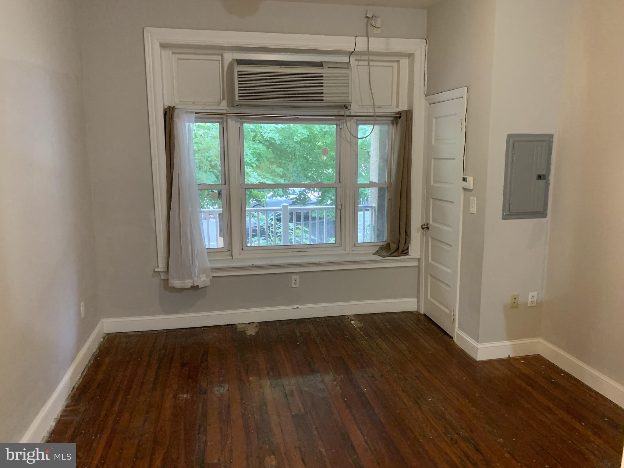4437 Chestnut Street, Unit 1F Philadelphia, PA 19104 - Photo 6 of 15 a view of a room with wooden floor and a window