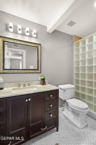 a bathroom with a glass door shower