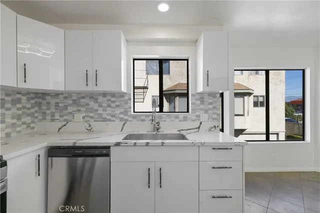 a kitchen with a sink cabinets and window