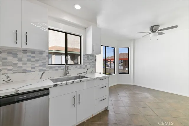 a kitchen with stainless steel appliances granite countertop a stove and a sink