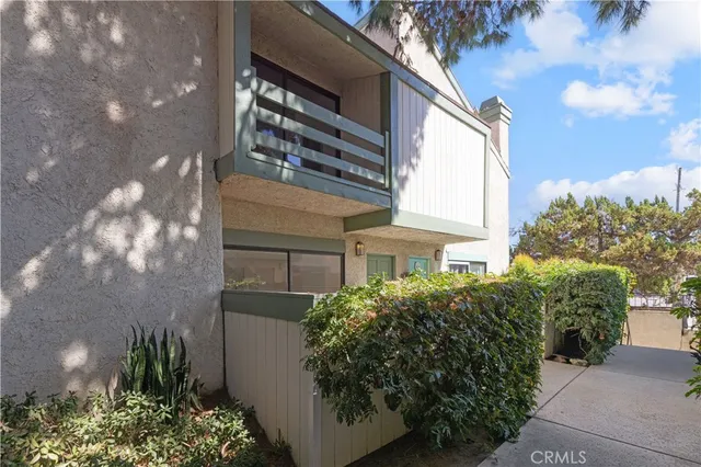 a view of a house with a plants and a pathway
