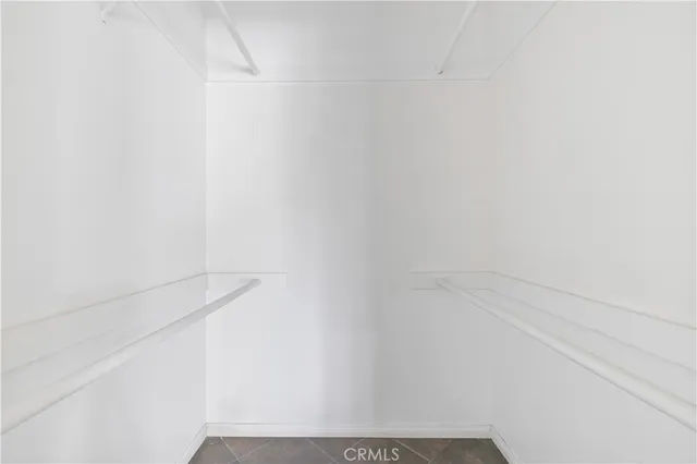 a view of an empty room with window and bathroom