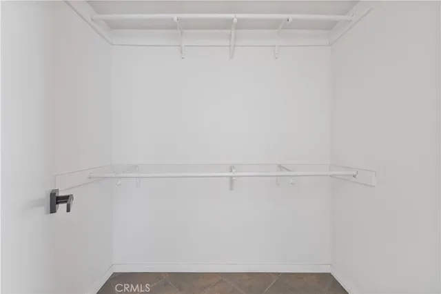 an empty room with kitchen space and bathroom view