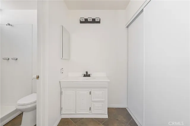 a view of a white house with a street