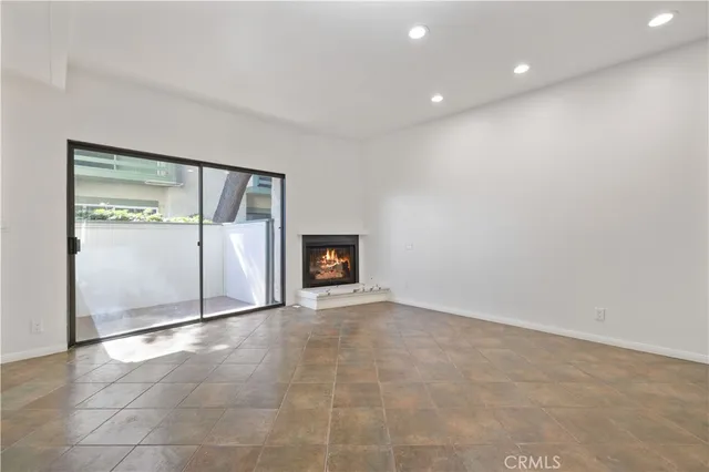 a view of an empty room with a fireplace