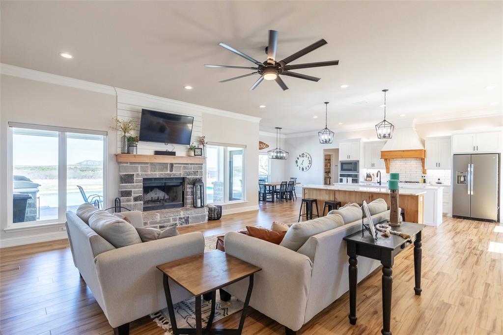 296 Mesquite Ridge Lane Lawn, TX 79530 - Photo 11 of 35 a living room with furniture a fireplace and a flat screen tv