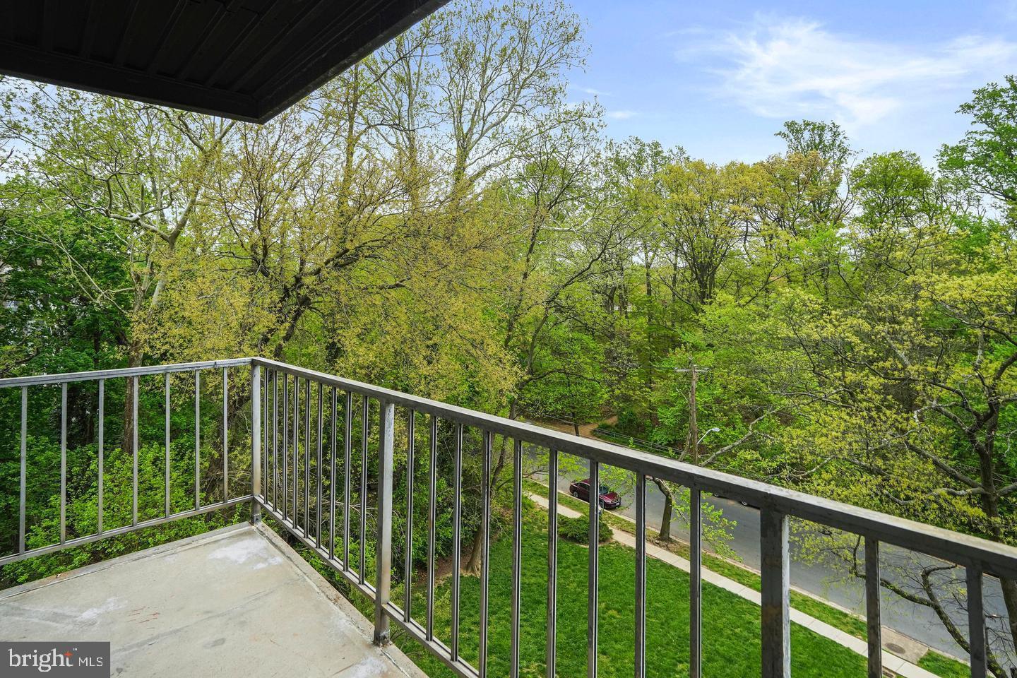 575 Thayer Avenue, Unit 404 Silver Spring, MD 20910 - Photo 17 of 26 a balcony with trees in the back