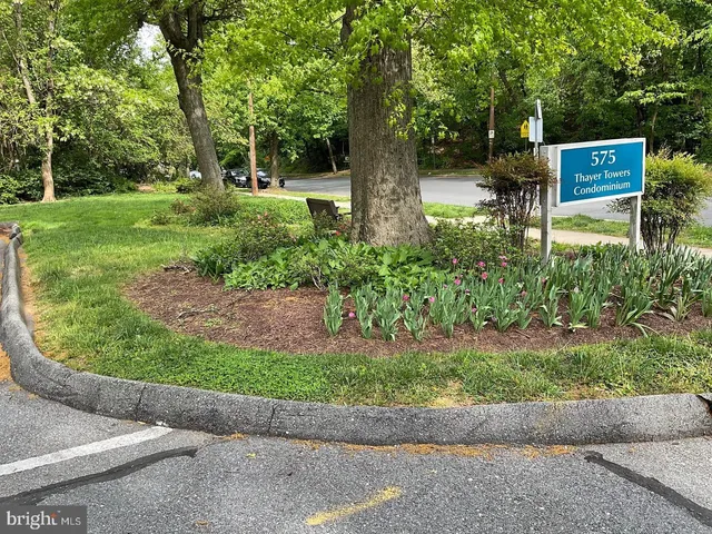 a backyard of a house with a garden and outdoor seating