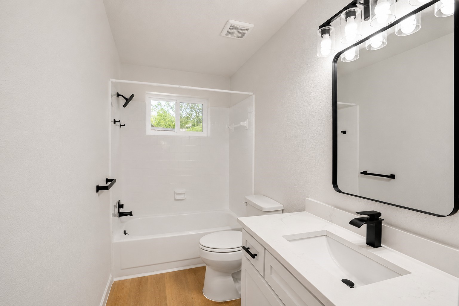 12703 Redfern Drive Houston, TX 77048 - Photo 22 of 28 Beautifully updated bathroom showcasing a modern vanity, sleek fixtures, and a clean tub/shower combo—blending contemporary upgrades with a fresh, timeless feel.