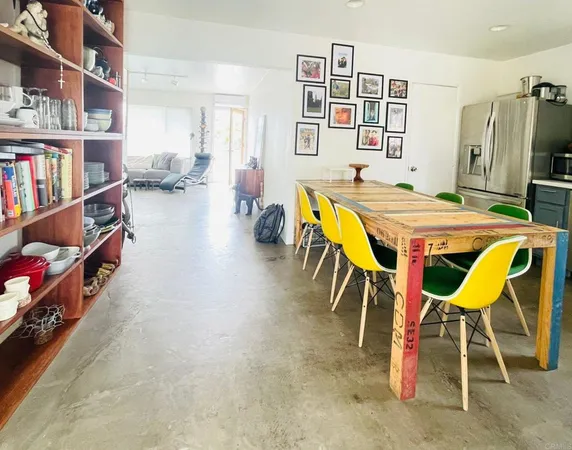 a dining room with furniture and a book shelf