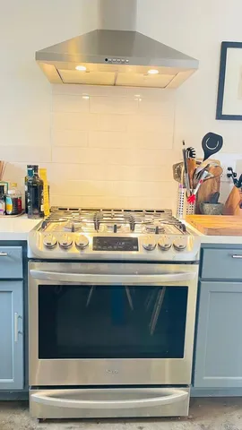 a stove top oven sitting inside of a kitchen