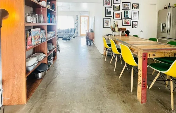 a view of a dining room with furniture and a book shelf