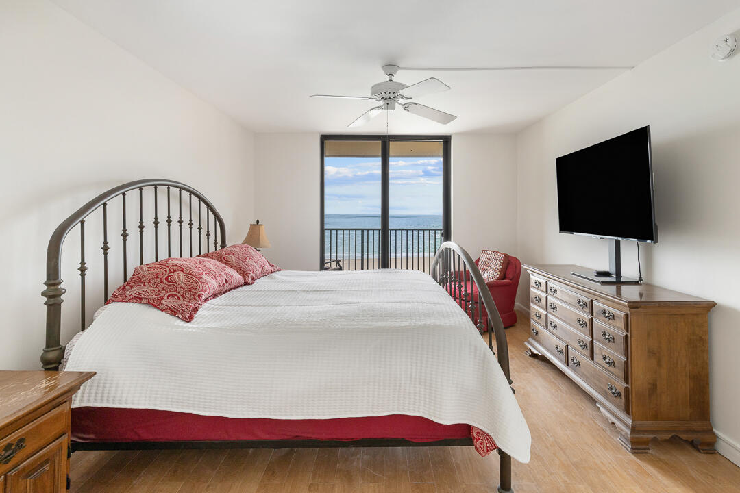 400 Ocean Trail Way, Unit 1108 Jupiter, FL 33477 - Photo 21 of 41 a bedroom with a bed and a flat screen tv