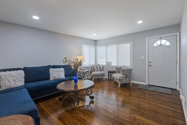 a living room with furniture a window and dining table