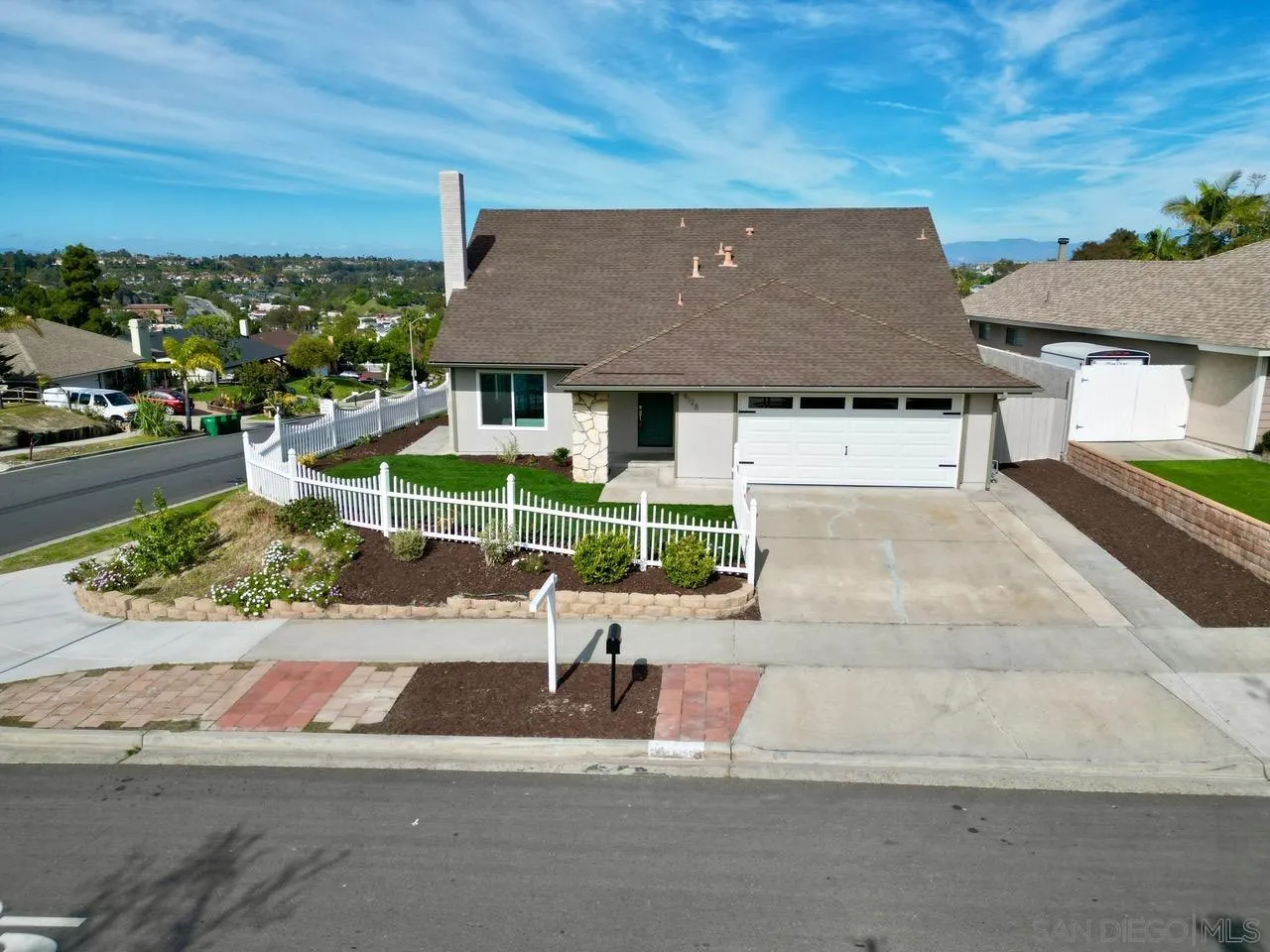 an aerial view of a house with a garden and mountain view