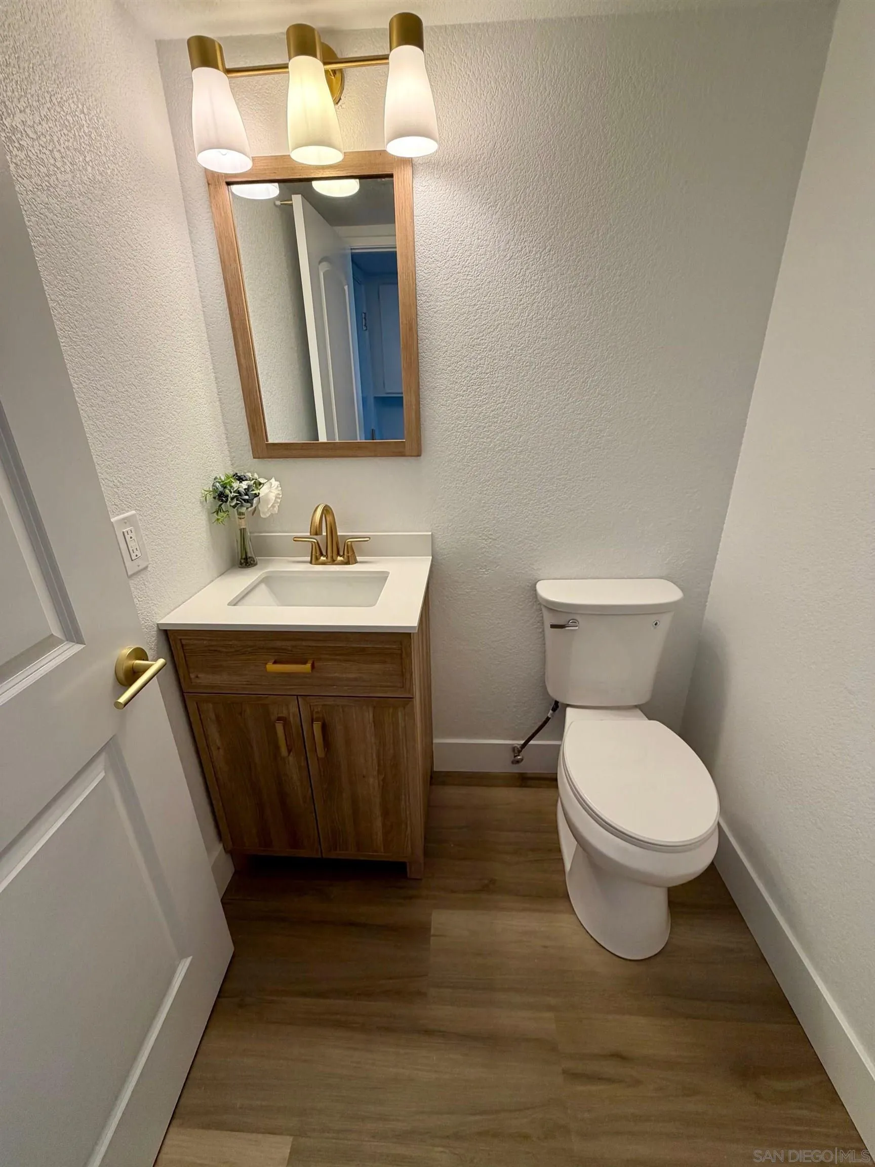 4128 Terry Street Oceanside, CA 92056 - Photo 13 of 21 a bathroom with a toilet sink and mirror