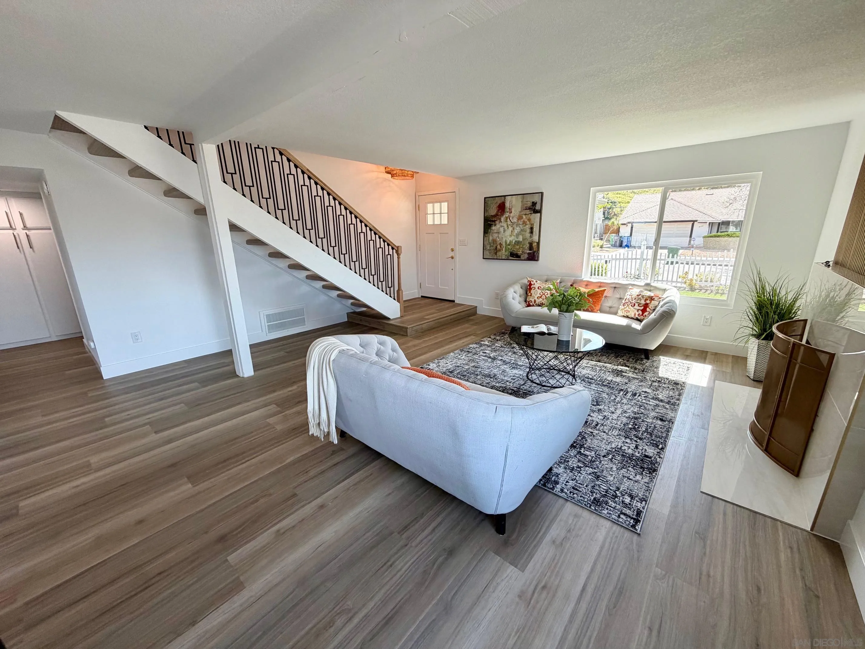 4128 Terry Street Oceanside, CA 92056 - Photo 2 of 21 a living room with furniture and a wooden floor